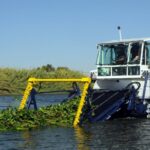 BERKY TRITON 1500 in use on water, collects aquatic plants