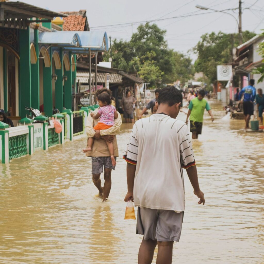 People walking through flooded streets